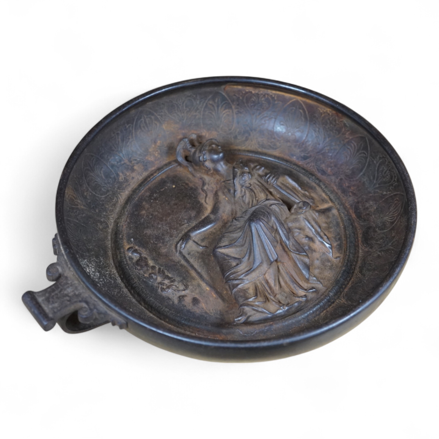 An early 20th century cast iron dish depicting Minerva, 28cm across. Condition - one handle missing